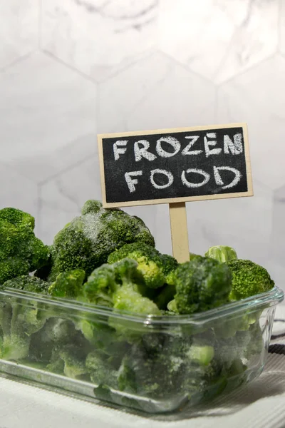 Frozen food broccoli florets with blackboard label and text FROZEN FOOD homemade. Harvesting concept. Stocking up vegetables for winter storage Healthy food, Cooking ingredients