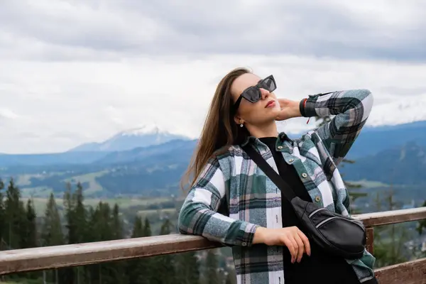 Young woman enjoying nature in Snowy Mountain in Polish Tatry mountains Zakopane Poland. Naturecore aesthetic beautiful green hills. Mental and physical wellbeing Travel outdoors tourist destination