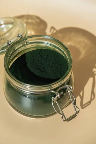 stock image Organic blue-green algae spirulina powder food in glass jar. Health benefits of spirulina chlorella. Dietary supplement superfood concept