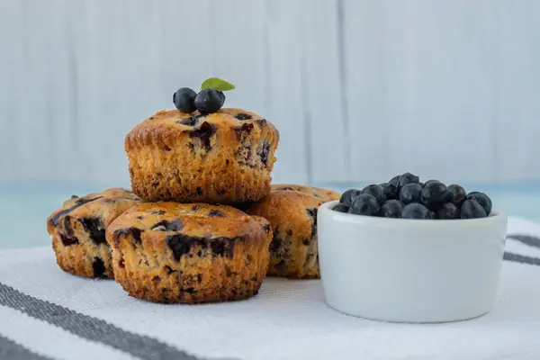Homemade baked blueberry muffins with fresh blackberries. Tasty pastry sweet cupcake dessert. Berry pie Healthy vegan cupcakes with organic berries. Gluten free healthcare recipe from alternative