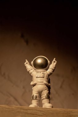 Plastic toy figure astronaut on moon concrete background Copy space. Concept of out of earth travel, private spaceman commercial flights. Space missions and Sustainability