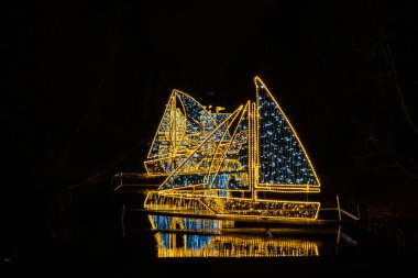 Oliva Park Gdansk Polonya 'da küçük gemiler ve tekneler tatil süslemeleri yaktı. Geceleri güzel bir Noel panayırı. Avrupa 'da kış uykusuna yatmış. Aralık 'taki Noel Pazarı Kutlama için süslendi 