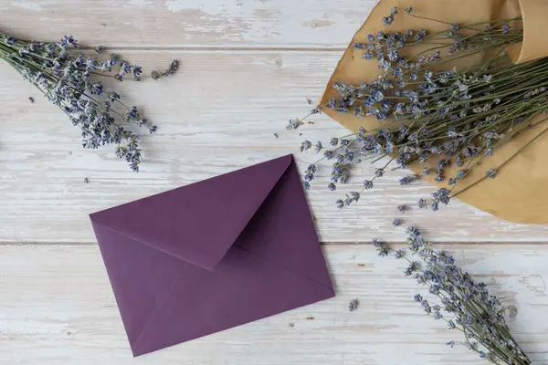 Empty violet envelope paper template mock up. Copy space for your text. Lavender flower. Greeting or invitation card blank with envelope. Top view, flat lay
