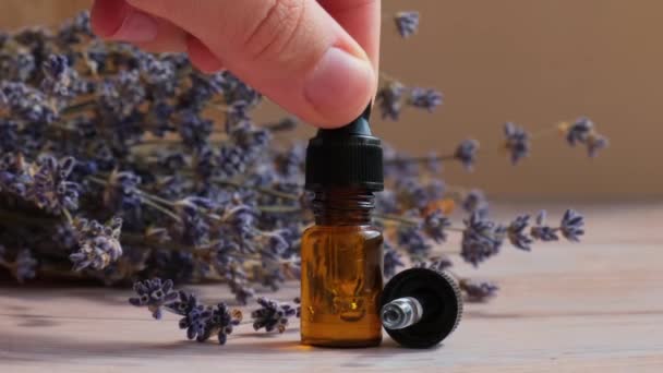 Vrouw Gebruikt Lavendel Bloemen Met Druppelaar Glazen Fles Etherische Olie — Stockvideo