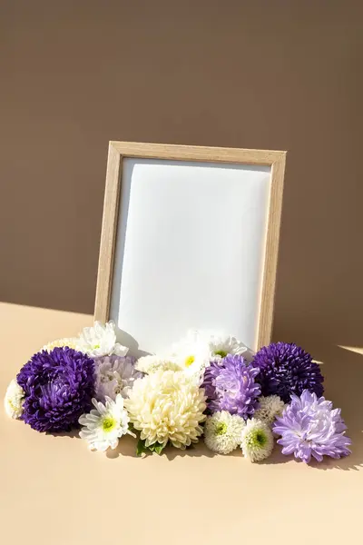 Empty paper frame with copy space for text. Mock up template. Isometric style Colorful white and violet flowers around. Holiday greeting card. Minimalistic spring concept womens day, easter