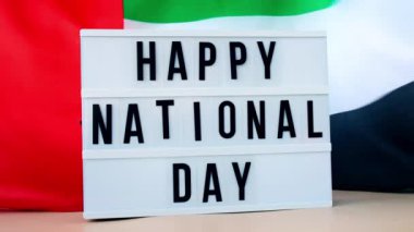 Birleşik Arap Emirlikleri 'nde ipekten yapılmış bayrak sallayan ışıklı kutu mutlu uluslar arası mesaj çerçevesi. Bağımsızlık Günü Müslümanların bayram kutlamaları. Ulusal Bayrak