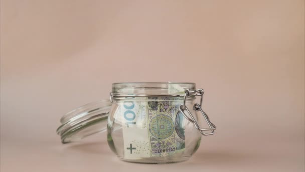 Stop Motion Polish Zloty Cash Banknote Collect Glass Jar Beige — Vídeo de stock