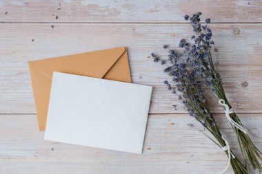 Boş beyaz zarf kâğıt kart şablonu. Metnin için alanı kopyala. Lavanta çiçeği. Selamlama ya da davetiye kartı içinde zarf yok. Üst manzara, düz uzanma