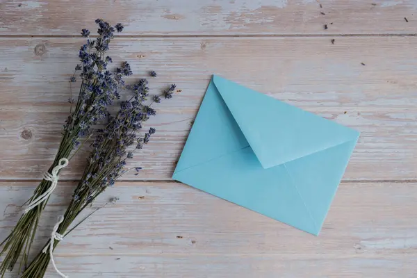 Empty blue envelope paper template mock up. Copy space for your text. Lavender flower. Greeting or invitation card blank with envelope. Top view, flat lay