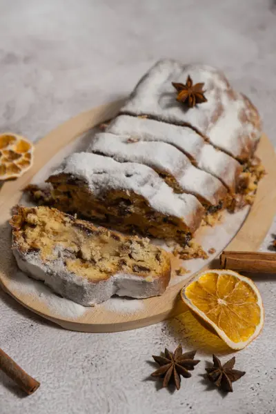 stock image Slices of Traditional German Christmas stollen cake in background of handmade festive decor. Winter holiday treats. Vegan baking recipe preparation