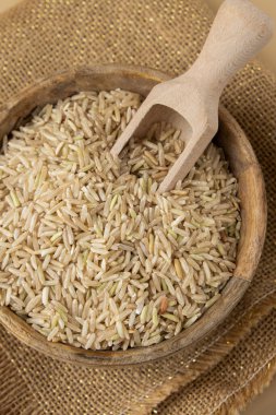 Tarafsız bej arka planda esmer pirinç kopyalama alanı. Tam hecelenmiş tahıl türü. Yüksek proteinli lif zengini vejetaryen gıda bileşeni. Glütensiz süper yiyecek sağlıklı beslenme alternatifi
