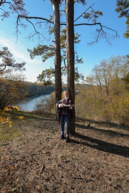 Güzel sarışın kız gitar çalıyor ve şarkı söylüyor güneşli bir sonbahar gününde dışarıda eğleniyor. Hippi kadın boho stilinde müzik enstrümanı çalıyor. Sonbahar mevsimsel havayı terk eder 
