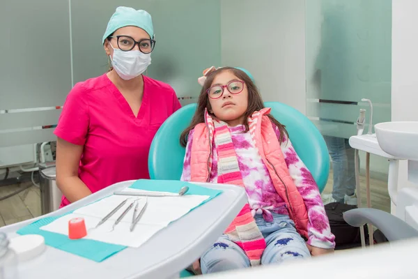 一个女牙医和她的病人在她的牙科诊所里 看着相机的肖像 — 图库照片