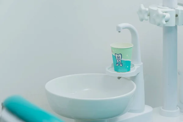 stock image Dental spittoon with a glass for water, in a dental clinic