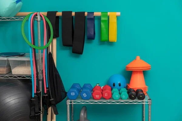 stock image Equipment for exercising, in a physiotherapy clinic, with dumbbells, balls, ropes and leagues.