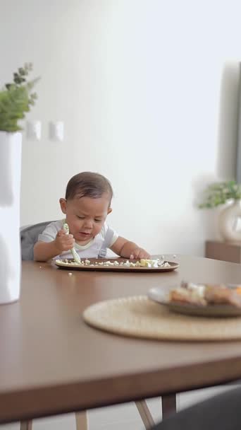 Baby Sitting Table Eating Hands Preloading Spoon — Stock Video
