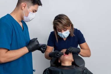 Doctor checking a womans lips after injecting botox