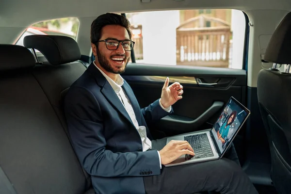 Businessman have a business meeting via video call while riding in car to office. High quality photo
