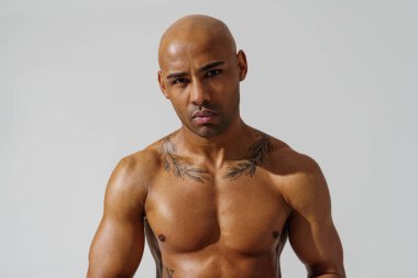 Attractive sporty man with muscled naked body on white studio background. High quality photo