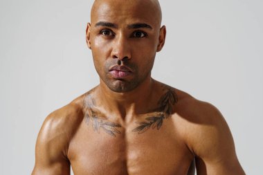 Attractive sporty man with muscled naked body on white studio background. High quality photo