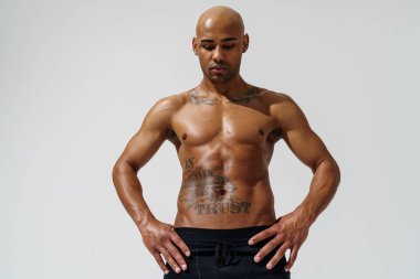 Attractive sporty man with muscled naked body on white studio background. High quality photo