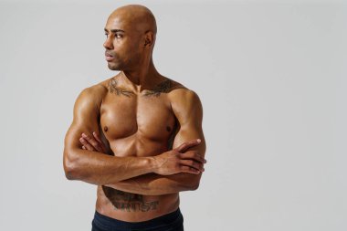 Attractive sporty man with muscled naked body on white studio background. High quality photo