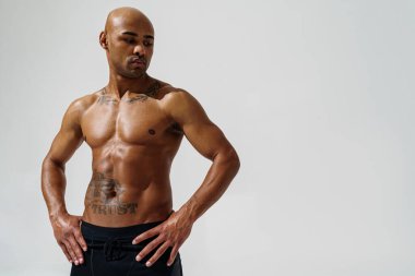 Attractive sporty man with muscled naked body on white studio background. High quality photo