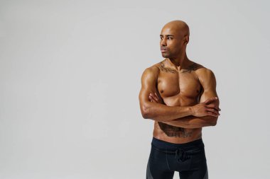 Attractive sporty man with muscled naked body on white studio background. High quality photo