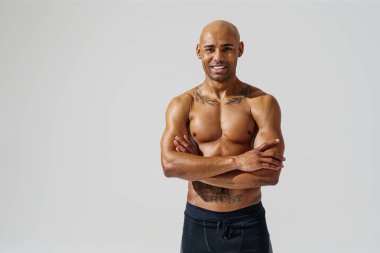 Attractive sporty man with muscled naked body on white studio background. High quality photo