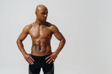 Attractive sporty man with muscled naked body on white studio background. High quality photo