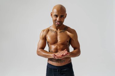 Attractive sporty man with muscled naked body on white studio background. High quality photo