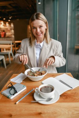 Businesswoman is having a business lunch during working day in cafe. High quality photo