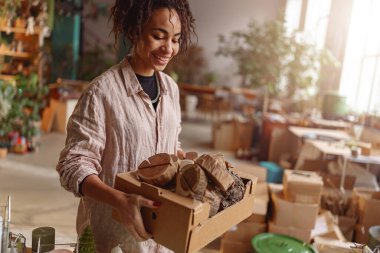 Woman working in home decor studio with elements of interior decorations. High quality photo