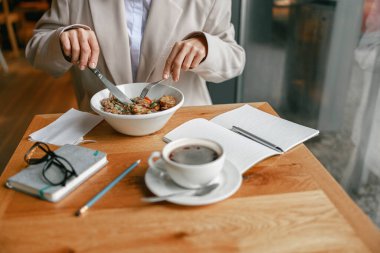 Businesswoman is having a business lunch during working day in cafe. High quality photo