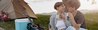 Romantic evening for couple in love at tent in wild nature. Drinking tea or coffee. Together in wild