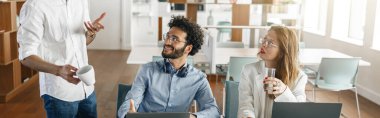 Group of coworkers working together analyzing the charts in office. Blurred background