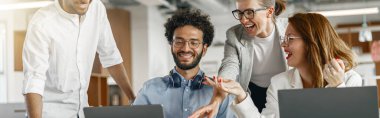 Coworkers cooperating and working together at office meeting, teamwork concept. Blurred background