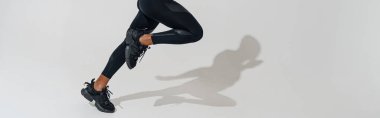 Professional male athlete running and looks ahead isolated on white studio background with shadows