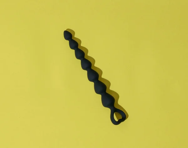 stock image Anal plug or dildo on yellow background with shadows. Sex toys for anal play. High quality photo