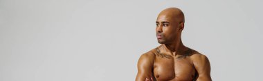 Attractive sporty man with muscled naked body on white studio background. High quality photo