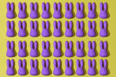 Many violet dildo vibrators for clitoris on yellow background. Sex toy for adult. High quality photo