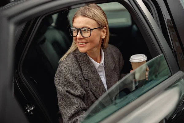 Bizneswoman Okularach Kawą Wynos Wysiadająca Samochodu Wysokiej Jakości Zdjęcie — Zdjęcie stockowe