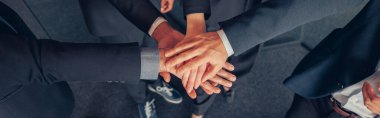 Group of coworkers stacked hands together as concept of corporate unity. High quality photo
