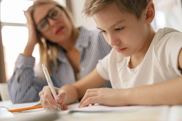 Tired Mom Helping Her Son Doing Homework Studying Online Using Royalty Free Stock Photos