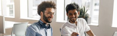 Coworkers cooperating and working together at office meeting, teamwork concept. Blurred background