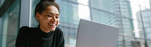 stock image Female freelancer working on laptop while sitting in cafe near window. High quality photo