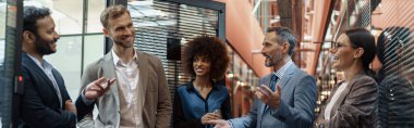 Businesspeople talking while standing in office during break. Teamwork concept. High quality photo