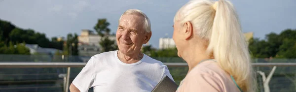 Gelukkige Oudere Man Blonde Vrouw Met Opgerolde Mat Staan Voetgangersbrug — Stockfoto