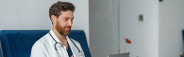 Doktor terapist video konsültasyonları yapar, hastayla laptopla iletişim kurar.