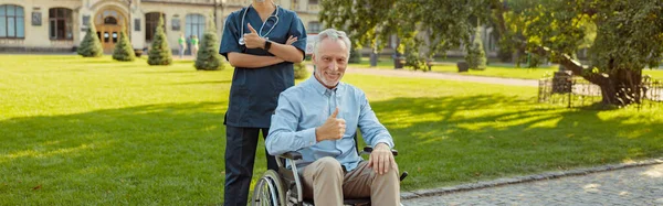 Homem Idoso Alegre Recuperando Paciente Uma Cadeira Rodas Sorrindo Para — Fotografia de Stock